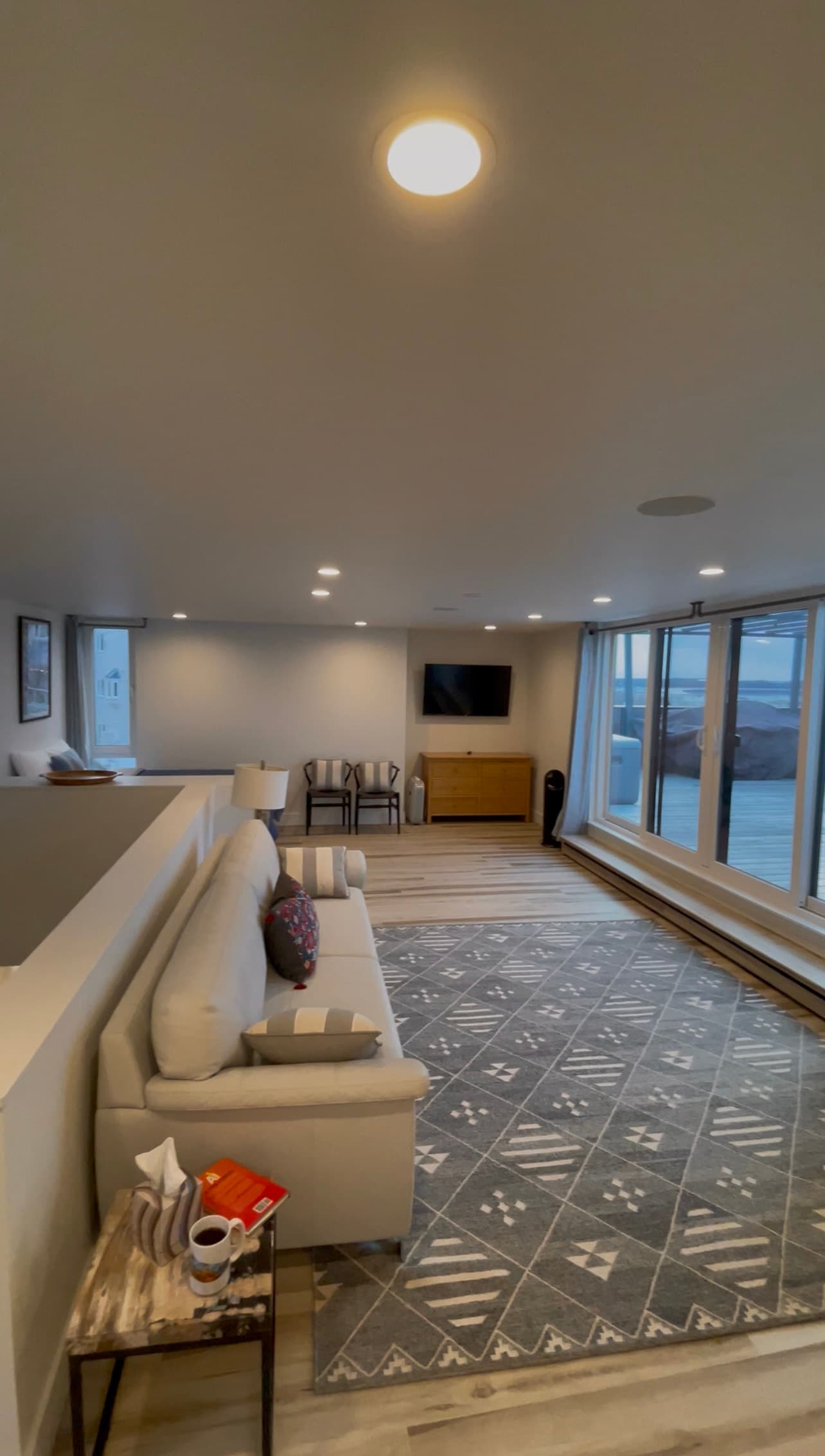 Third floor loft lounge with sectional sofa and rooftop deck access, Villa at Bootleggers Landing luxury Anchorage rental